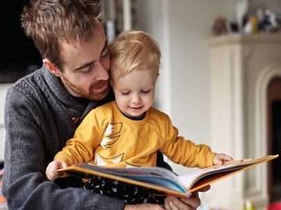 a father reading a book with his child